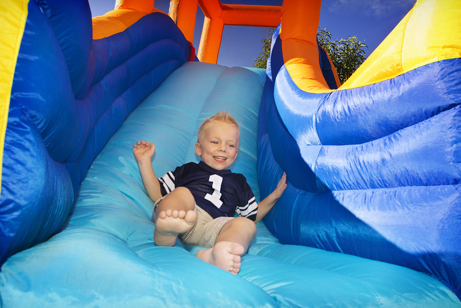 kid playing the inflatable water slide